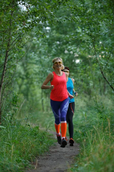 两个女运动员训练在树林里 — 图库照片