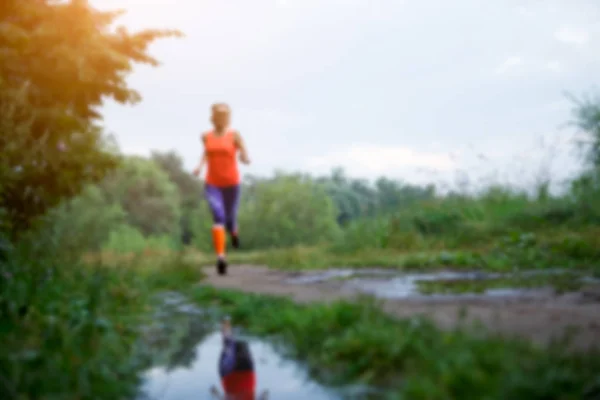 Blurred photo of running sportswoman — Stock Photo, Image