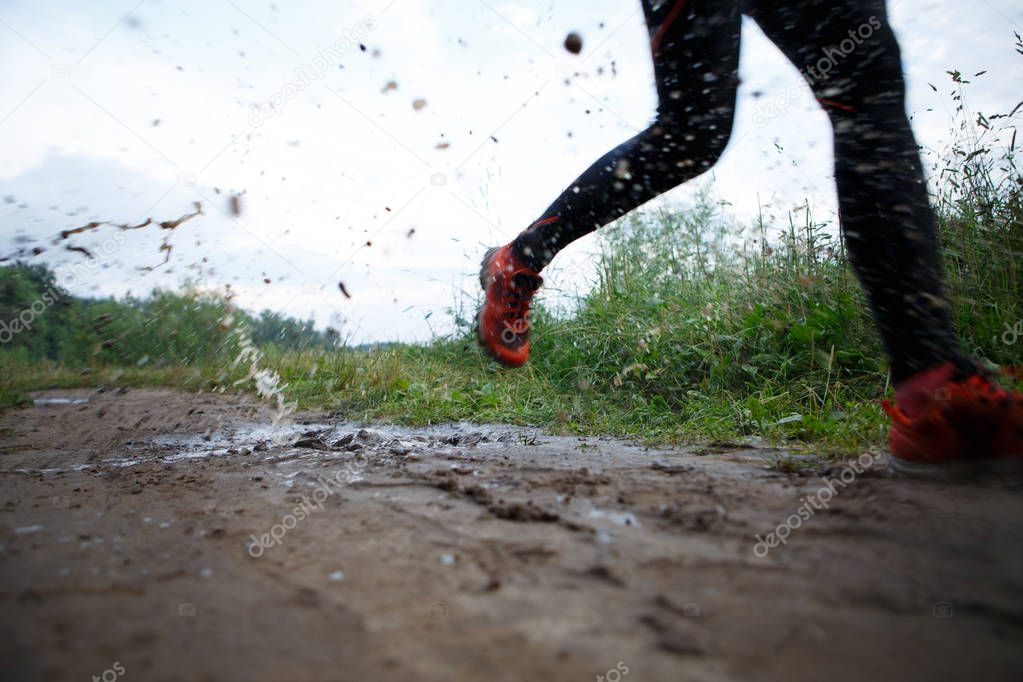 One girl running through puddle