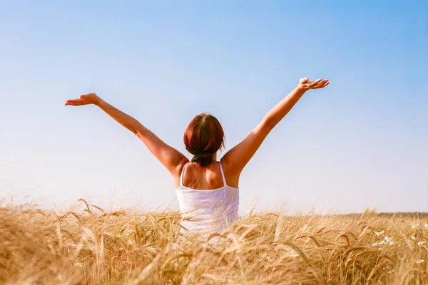 Photo from back of brunette with arms raised — Stock Photo, Image