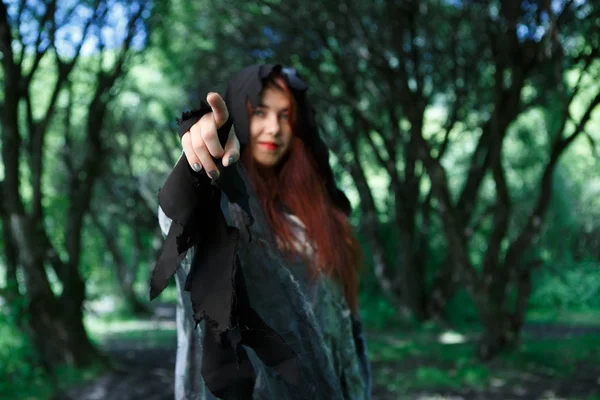 Witch points finger in forest — Stock Photo, Image