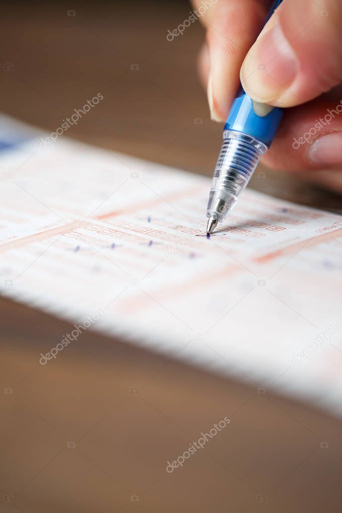 Photo of person marking in lottery ticket