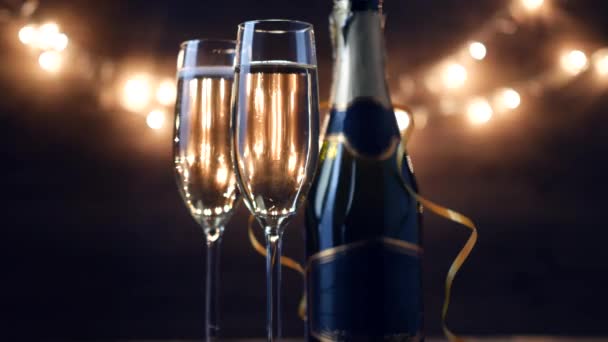 Two Flutes with Sparkling Wine over Holiday Bokeh Blinking Background. ultra hd footage.