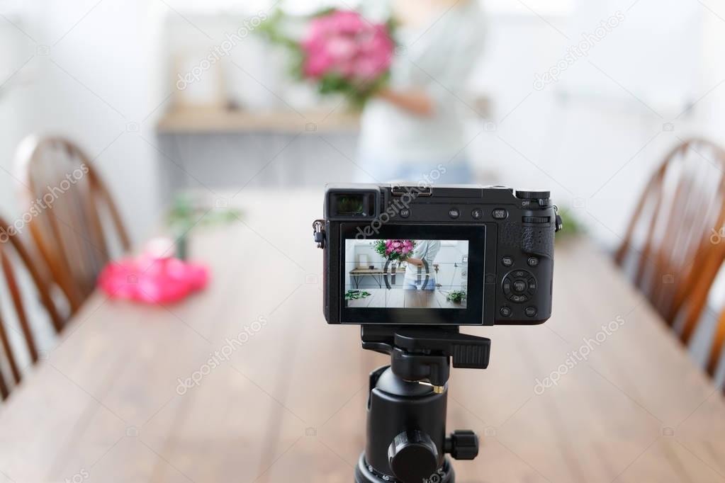 Bokeh photo of woman blogger recording on camera master class