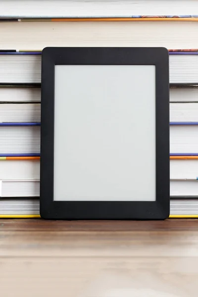 Blank black picture frame next to books — Stock Photo, Image