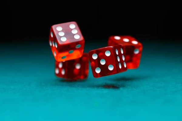 Photo of four playing red dices on green table — Stock Photo, Image