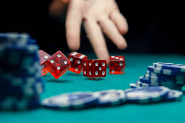 Image of man throwing dice on table with chips in casino — Stock Photo, Image