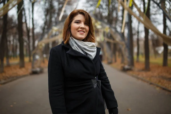 Photo of young girl in black coat and scarf — Stock Photo, Image