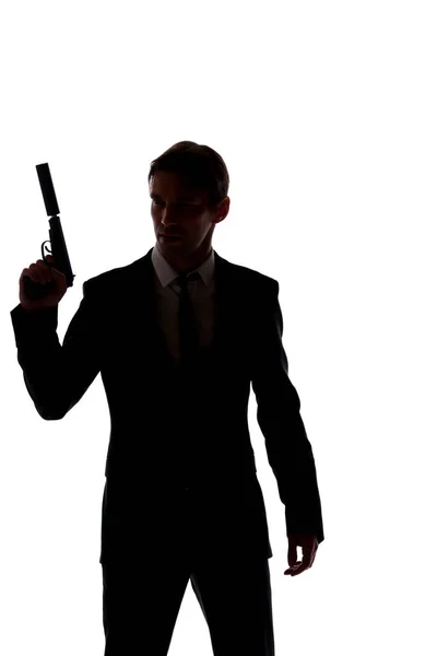 Σιλουέτα του ανθρώπου σε επαγγελματικό κοστούμι με το όπλο στο χέρι που απομονώνονται σε λευκό φόντο — Φωτογραφία Αρχείου