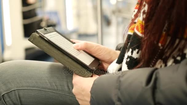 Young woman read e-book in subway train at metro — Stock Video