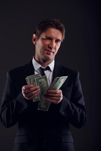 Photo of banker in suit counting dollars