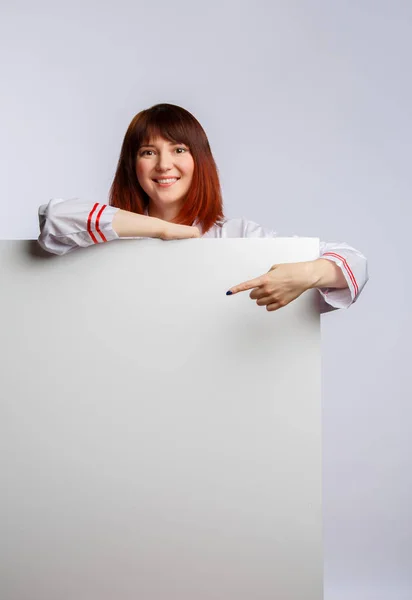 Image of chef girl in white lab coat with empty sheet for inscription — Stock Photo, Image