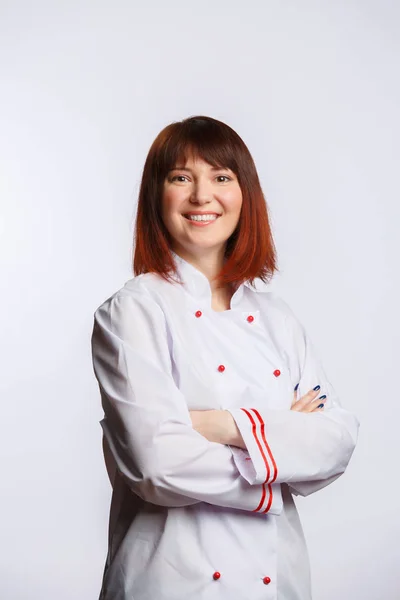 Picture of brunette chef in white robe with arms crossed at waist — Stock Photo, Image