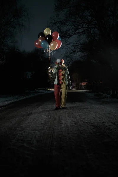 Bild av clown med bollar i händerna på natten på gatan — Stockfoto