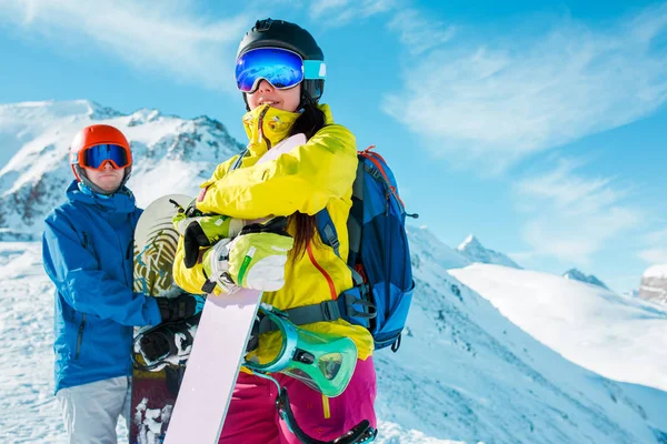 Imagen de hombre y mujer deportistas con snowboard sobre el fondo de colinas nevadas —  Fotos de Stock
