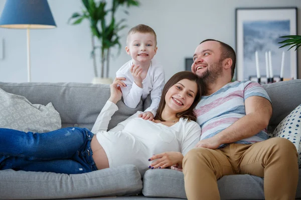 Photo of happy parents with small son on sofa — Stock Photo, Image