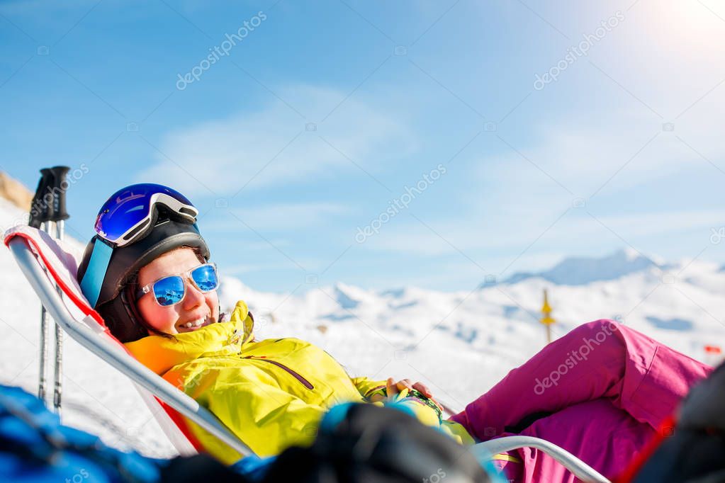 Picture of smiling sports woman lying on deckchair