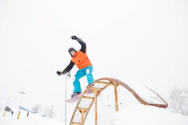 Resim sportif gencin snowboard sıçrama tahtası ile Kayak