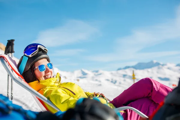 Photo of smiling sports woman lying on winter deckchair — Stock Photo, Image