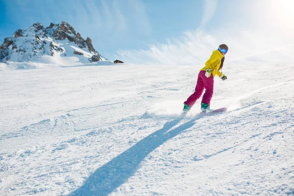 Image of sports woman snowboarding on snowy slope