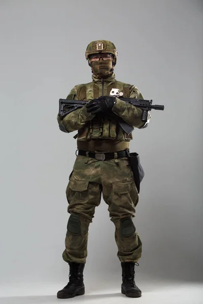 Image of soldier in camouflage with gun in studio — Stock Photo, Image