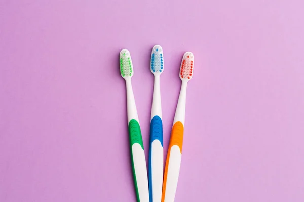 Photo of three multi-colored toothbrushes — Stock Photo, Image