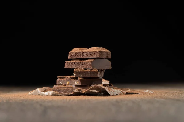 Chocolate on empty black background — Stock Photo, Image