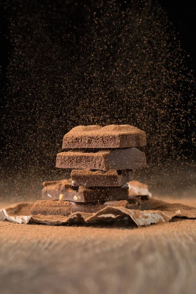 Broken chocolate on baking paper — Stock Photo, Image