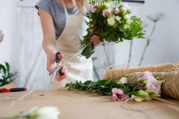 Girl florist makes beautiful bouquet