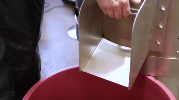 Смажені кавові зерна, що виливаються з картопляної машини — стокове відео
