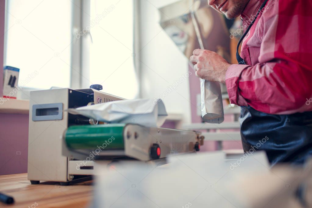 Photo of businessman weighing paper bags