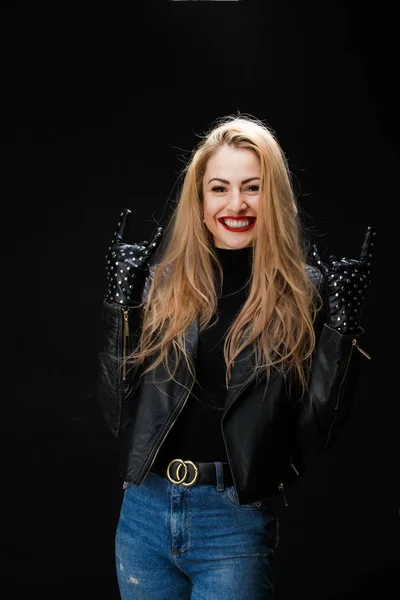 Image of young blonde in leather jacket showing goat gesture — Stock Photo, Image