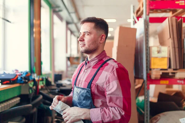 Foto van de man in schort met zak in handen bij shop voor het maken van koffie — Stockfoto