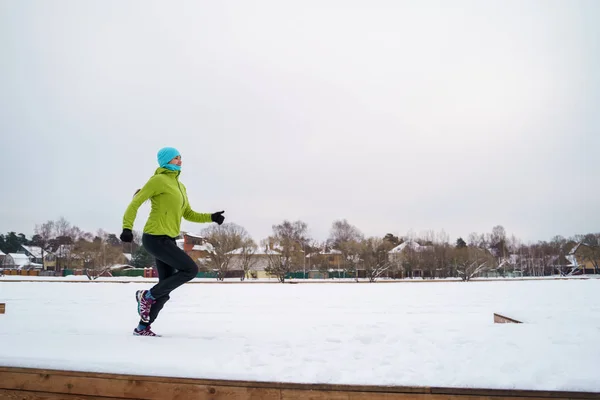 Bild einer jungen Athletin beim Laufen im Winterpark — Stockfoto