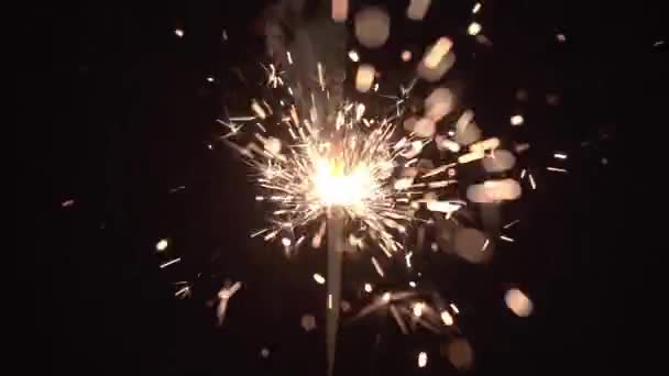 Burning sparkler bengal fire on black background. — Stock Video