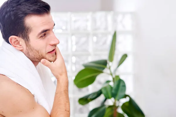 Man with white towel on his neck in bathroom — Stock Photo, Image