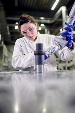 Laboratory assistant in white coat with 3D printer on blurred background
