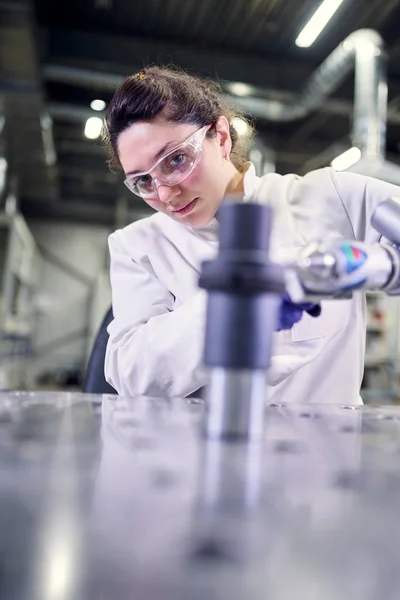 Assistante de laboratoire féminine en manteau blanc avec imprimante 3D sur fond bokeh — Photo