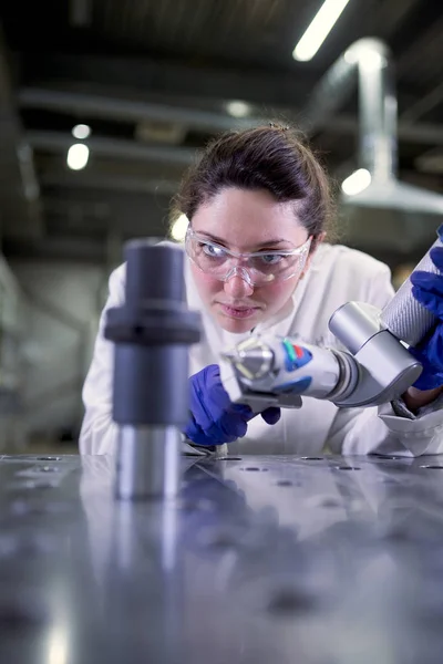 Female lab technician in blue rubber gloves with 3D printer on defocused background — Stock Photo, Image