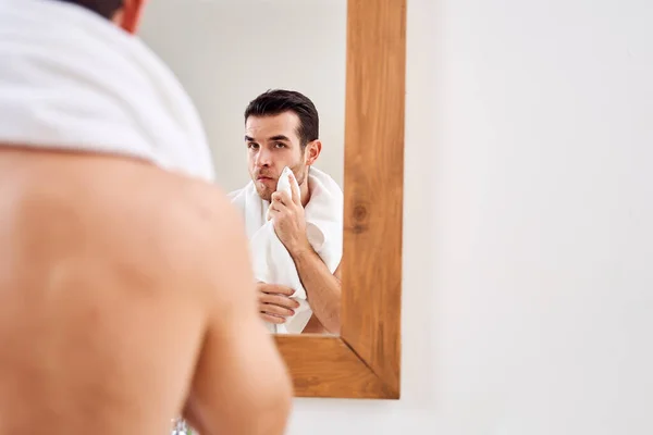Male wipes his towel while standing by mirror in bath in morning. — Stock Photo, Image