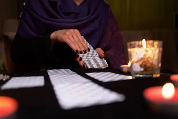 Mitt-reader woman guessing on cards sitting at table with burning candles, magic ball. — Stock Photo, Image