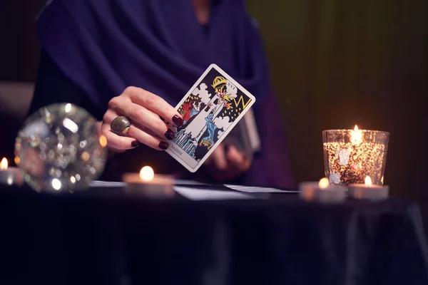 12.02.20. Moscow, Russia. Fortuneteller female divines on cards at table with candles in dark room — Stock Photo, Image