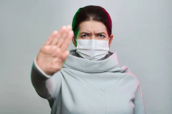 Girl in medical mask with outstretched arm isolated in studio — Stock Photo, Image