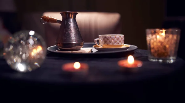 Dark fortune teller room with candles, turk, coffee mug on table — Stock Photo, Image