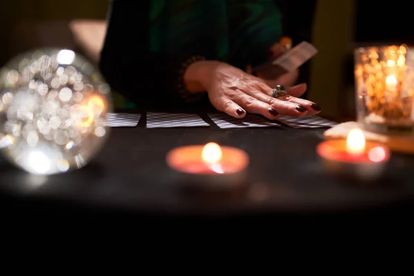 Woman fortune-tellers hands, fortune-telling cards, ball of predictions on black table — Stock Photo, Image
