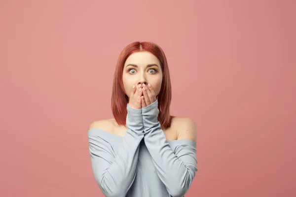 Surprised ginger girl covering her mouth with hands — Stock Photo, Image