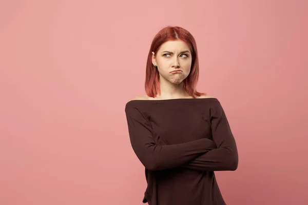 Upset young woman with gray eyes with arms crossed — Stock Photo, Image