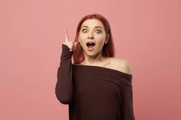 Surprised ginger girl with raised hand — Stock Photo, Image