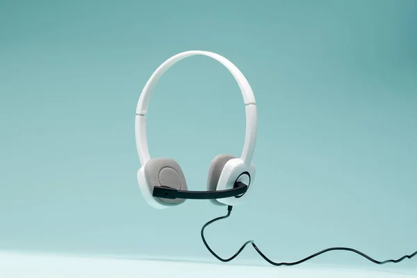 Headphones isolated on empty blue background. — Stock Photo, Image