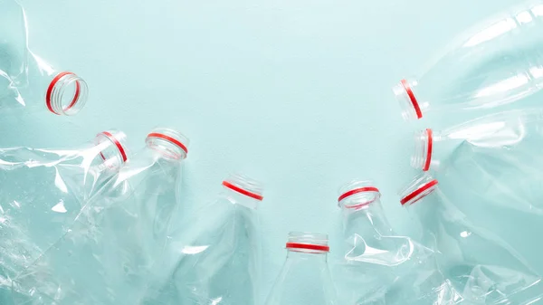 Empty crumpled plastic bottles at blue background — Stock Photo, Image